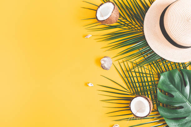 istock Summer composition. Tropical palm leaves, hat, coconut on yellow background. Summer concept. Flat lay, top view, copy space 1138230337