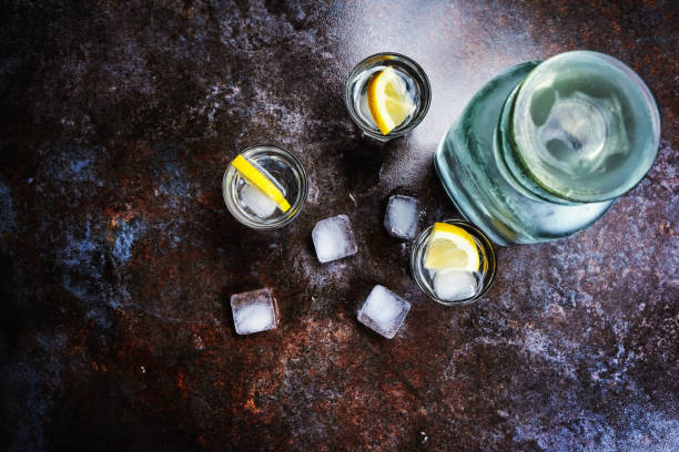 istock Vodka in glasses with lemon and ice. On the black stone table. Copyspace. 1138231822