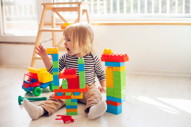 istock Angry little child playing with colorful plastic blocks 1138232887
