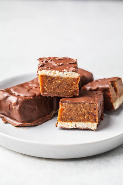 istock Vegan cocoa dates chocolate raw bars on white background. 1138233262
