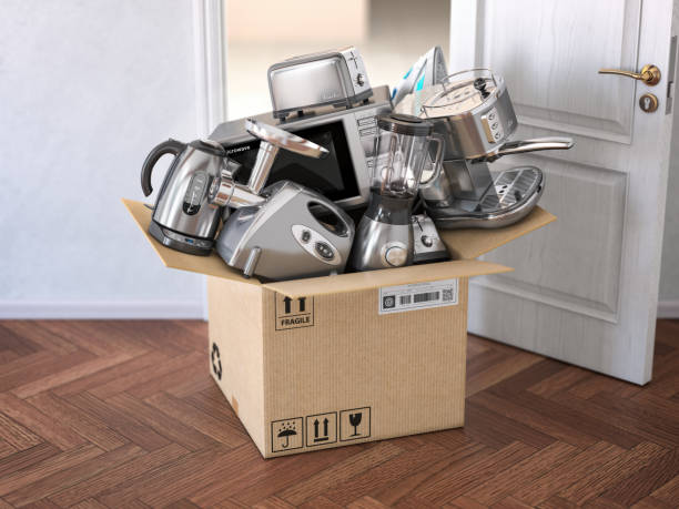 istock Household  kitchen appliances in open cardboard box  in front of open door. Delivery,  e-commerce and online shopping concept. 1138234321
