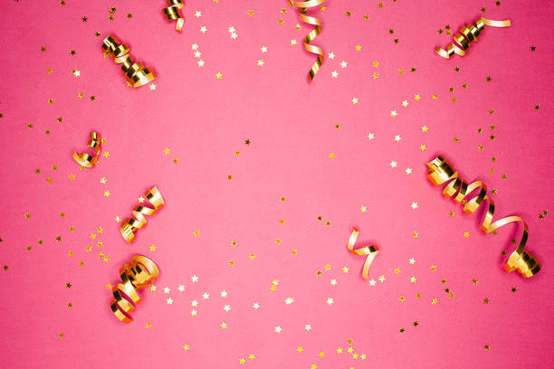 istock Golden decorations and sparkles on pink background 1138235672