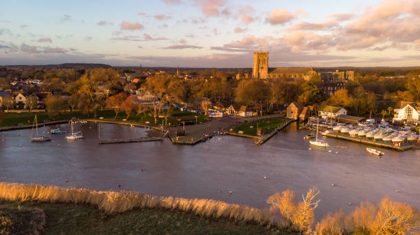 Aerial town view along a river at golden hour Aerial town view along a river at golden hour christchurch england photos stock pictures, royalty-free photos & images