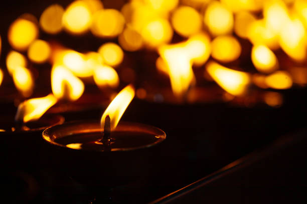 istock Many candle flames glowing in the dark 1138239088
