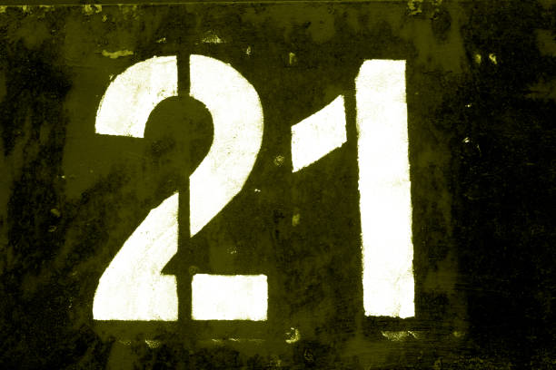 istock Number 21 in stencil on metal wall in yellow tone. 1138242156