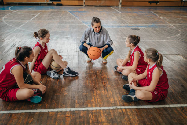 istock Female coach with basketball team 1138243146