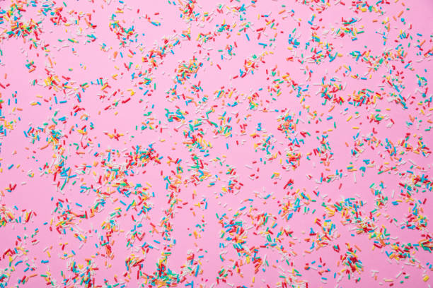 istock Birthday concept. Colorful sprinkles on pink background 1138244401