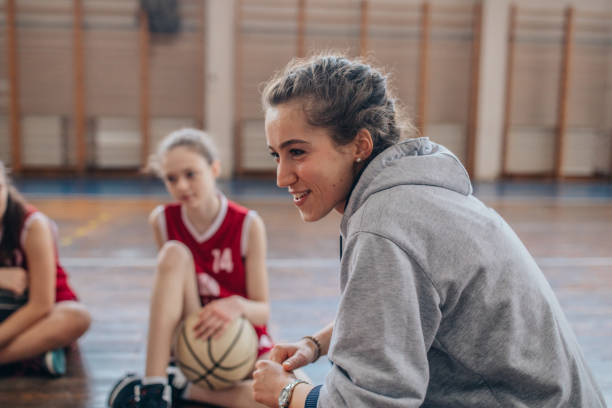 istock Female coach with basketball team 1138244638