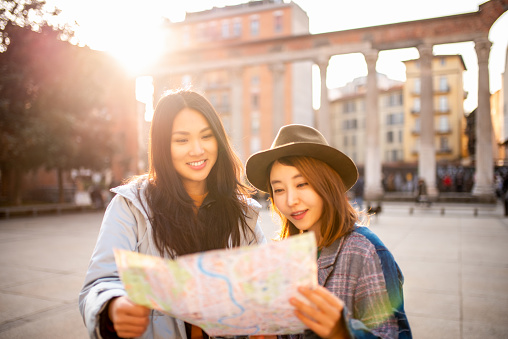 Two smiling Asian girls visiting Italy.