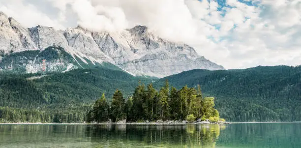Panorama of an island in the middle of lake Eibsee mountains in the background