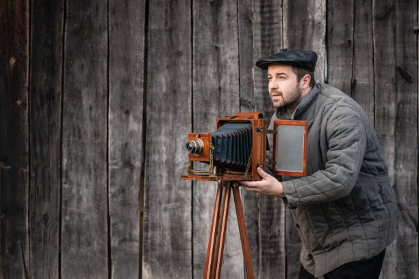 old fashioned photographer works with large format camera. concept - photography of the 1930s-1950s - bellow camera photography photography themes photographer imagens e fotografias de stock