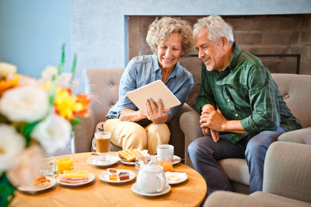 istock Smiling retired couple sharing digital tablet 1138248819