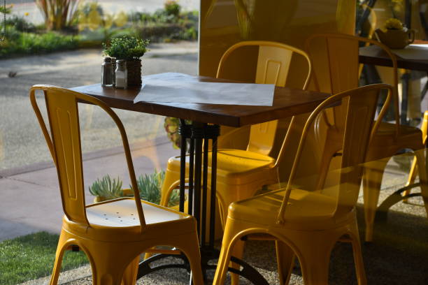 istock Yellow Table and Chairs in Afternoon Sunlight through window 1138249023