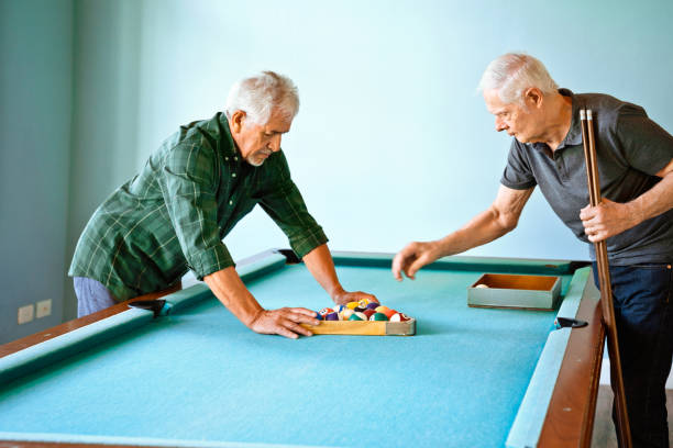 istock Senior friends arranging balls on pool table 1138250162