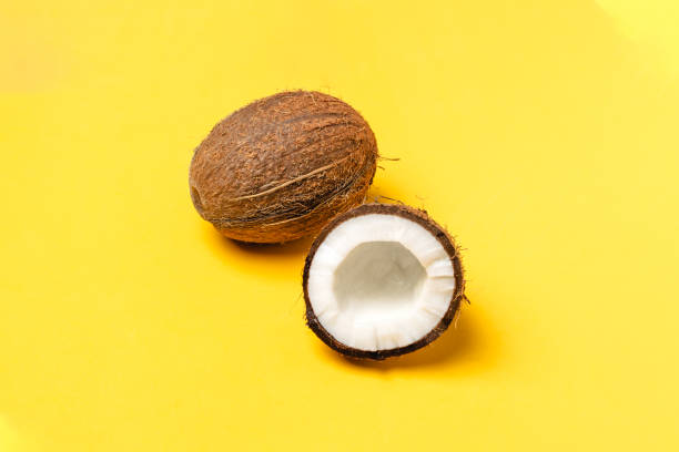 istock Ripe coconuts and half coconut on bright blue background, minimal composition, tropical fruit concept, flat lay, pop art 1138250164