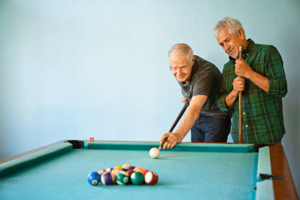 istock Senior men playing pool ball at nursing home 1138250289