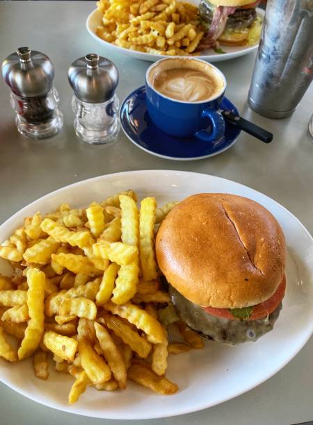 Burger, french fries, milkshake and coffee in an American diner
