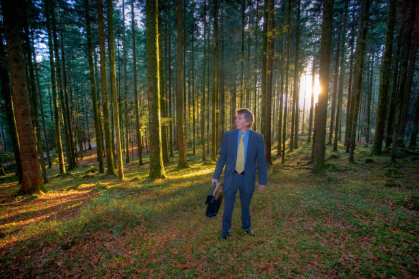 Middle aged caucasian businessman lost in a forest