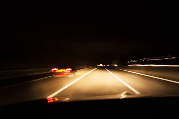 istock Car driving on unlit road 1138253379