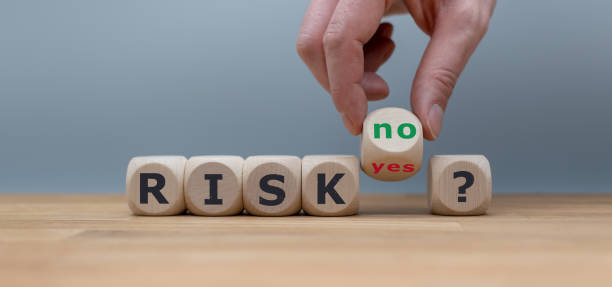istock Taking a risk? Hand turns a dice and changes the word 