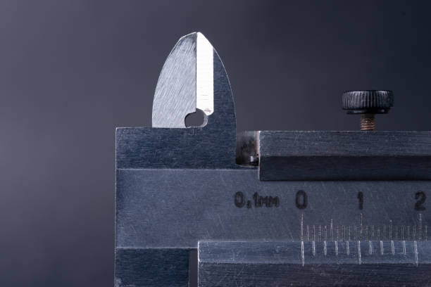 istock Vintage steel caliper tool closeup. Caliper tips and scale in focus. Tool in very good condition. Scale in metric units, milimeter step. Stock photo on blurred gray background. 1138254012