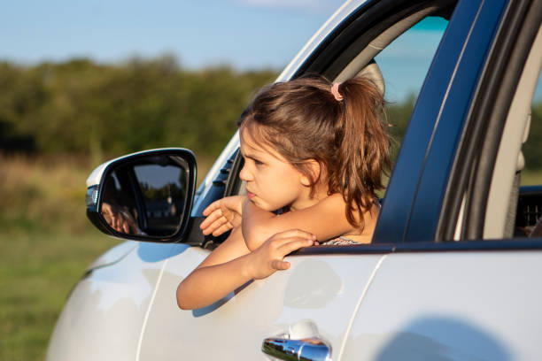 istock Young female looking out of car window 1138254789