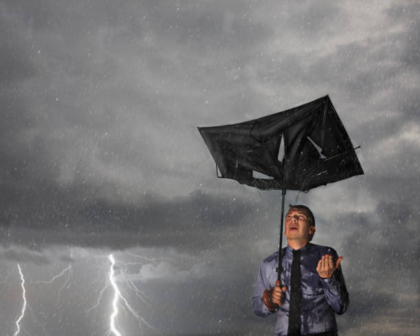 businessman caught in a storm - rain drenched men wet imagens e fotografias de stock