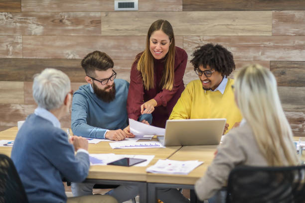 istock Group of multi generation business colleagues in open hub office 1138255446