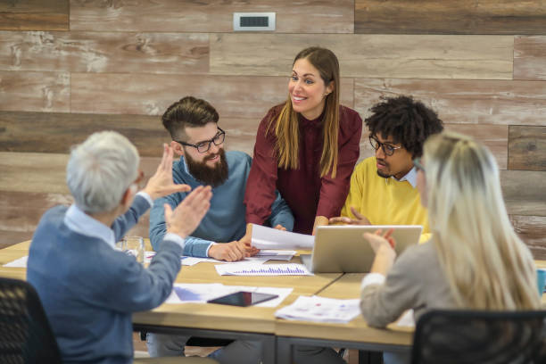 istock Group of multi generation business colleagues in open hub office 1138256016