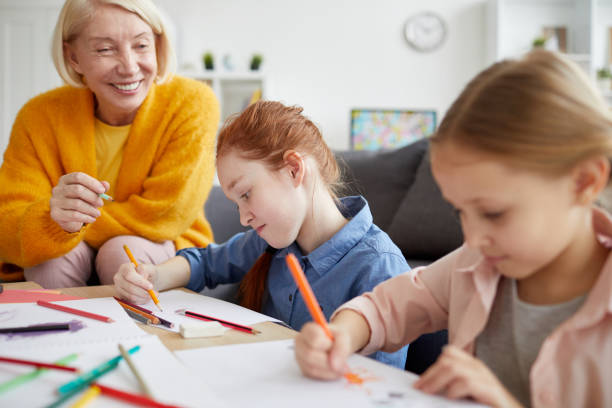 istock Two Girls Drawing with Mom 1138257792
