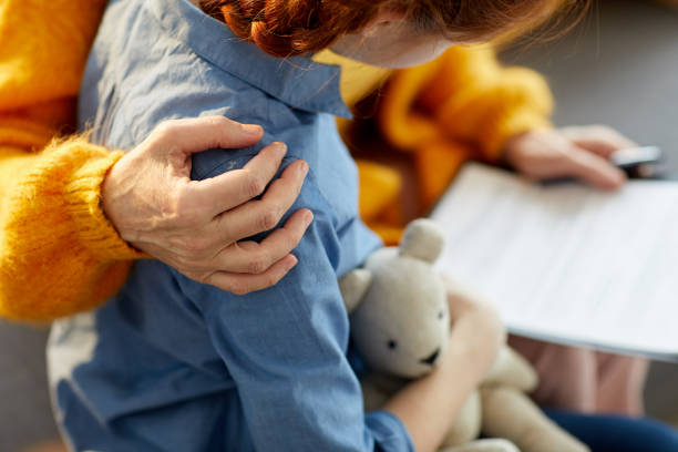 Caring Embrace Closeup of unrecognizable woman hugging teenage girl with care and love, copy space childhood stock pictures, royalty-free photos & images