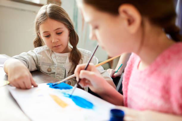 istock Two Sisters Painting Together 1138260058