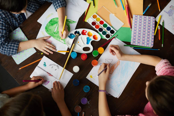 istock Group of Children Drawing Above View 1138260059