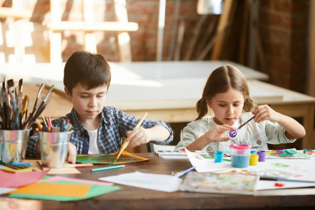 istock Brother and Sister Painting 1138260094