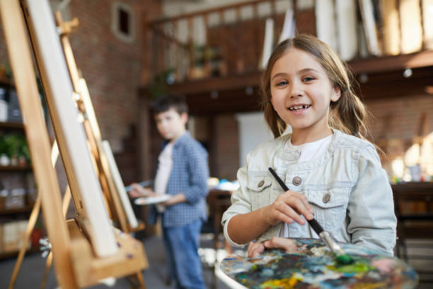 istock Little Girl Posing in Art Class 1138260108