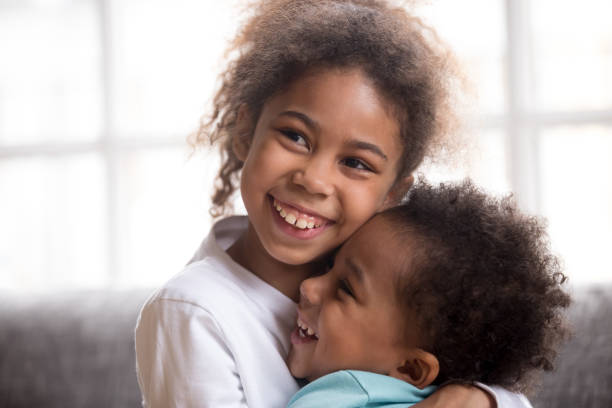 istock Funny black siblings hug making peace after fight 1138263346