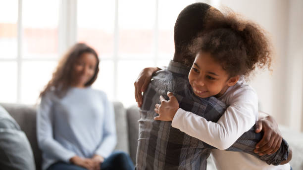 istock Happy black girl hugging young dad at home 1138263349