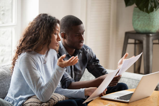 istock Concerned black couple read bills considering paperwork at home 1138263354