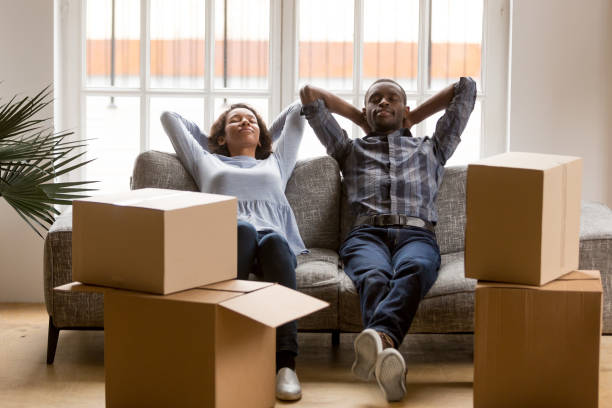 black young couple relax on couch tired on moving day - african descent american culture exercising women imagens e fotografias de stock