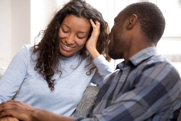 istock Happy black couple relax on couch talking holding hands 1138263378
