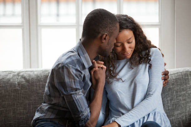 istock Loving black couple hug on couch making peace after fight 1138263380