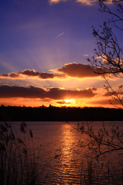 istock Sun with its rays through the clouds over the lake 1138263399