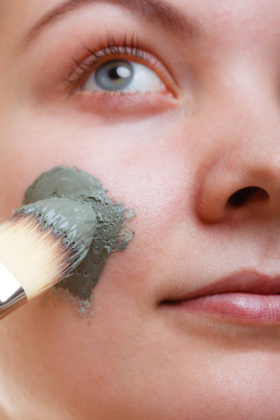 istock Woman having mud green mask on her face 1138266921