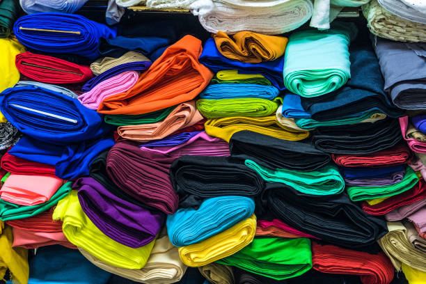 istock Colorful fabrics in warehouse. Rolls of fabrics for sewing. 1138269200