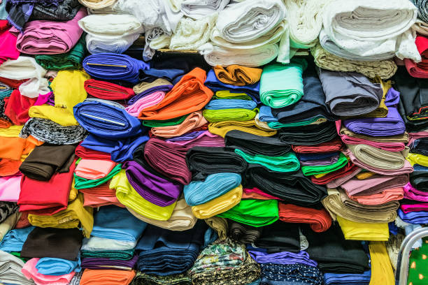 istock Colorful fabrics in warehouse. Rolls of fabrics for sewing. 1138269201