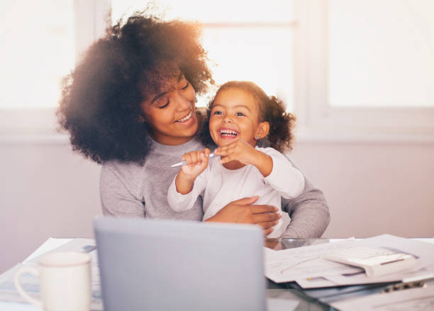 istock Young mother working and spending time with her daughter 1138269281