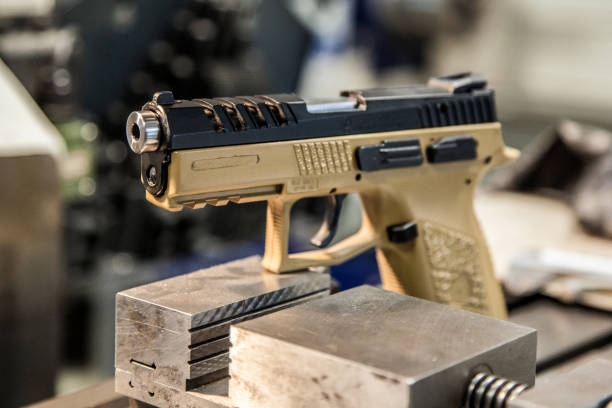 istock modern pistol on the table in the workshop 1138272454