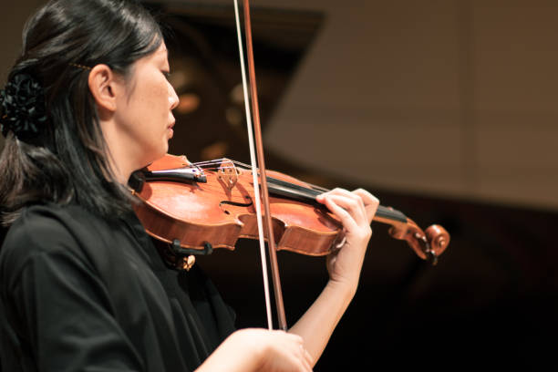istock Violinists playing at classical music concert 1138273836