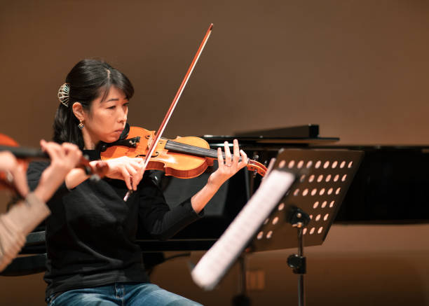 istock Female violinist playing at classical music concert 1138273840