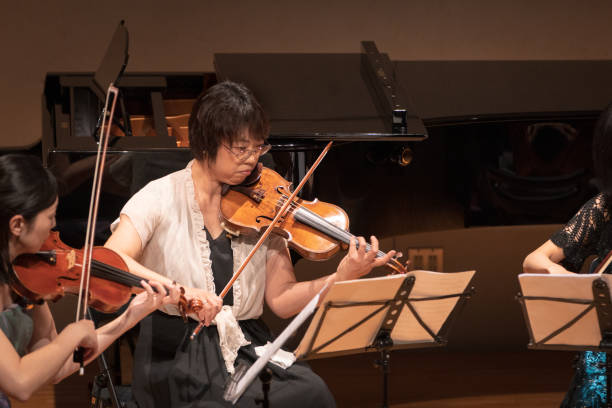 istock Female violinists playing in classical music concert 1138273848